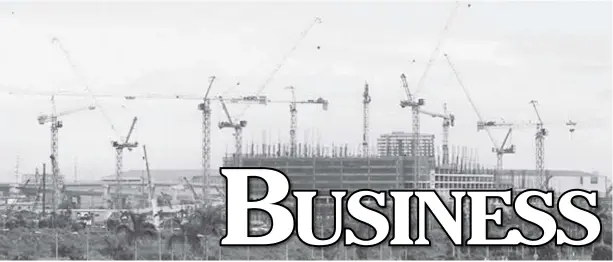  ?? AP ?? Constructi­on cranes sprout out from reclaimed land in suburban Paranaque, south of Manila.