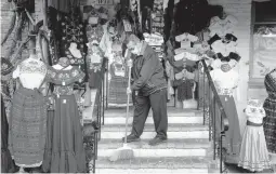  ?? JAE C. HONG/AP 2020 ?? Victor Flores, a third-generation owner of a gift shop, sweeps up at his store in Los Angeles. A new round of coronaviru­s relief is on the way for small-business owners.