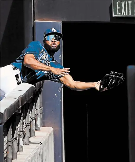  ?? SEAN M. HAFFEY/GETTY ?? Rays outfielder Manuel Margot makes an acrobatic catch in right field during Game 2 of the ALCS on Monday.