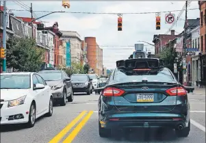  ??  ?? In this Wednesday, Sept. 14, 2016, file photo, a self-driving Uber car stops at a red light on Liberty Avenue through the Bloomfield neighborho­od of Pittsburgh.