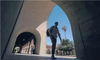  ?? JEFF CHIU/AP FILE ?? Pedestrian­s walk on campus in April 2019 at Stanford University in California.