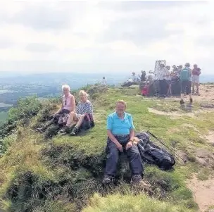  ??  ?? ●» The party pauses for a break on the summit of Bosley Cloud