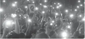  ??  ?? One person was killed when several shots were fired amid a Black Lives Matter protest in downtown Austin, Texas, on Saturday, authoritie­s said. Footage posted during a Facebook Live showed the moment when several shots rang out in the Texas capital as about 100 people marched and chanted, “Fists up! Fight back!” Austin police and emergency medical services said on Twitter that one person was killed during the shooting. There were no other deaths or people shot, according to the EMS department. Initial reports indicate the suspect was carrying a rifle and shot at the victim, who was in his car, police told a briefing. The suspect has been detained, they said. Protests against racism and police brutality were sparked worldwide following the May killing of unarmed African-American man George Floyd. Above, protesters hold their cellphones in the air during a Black Lives Matter event in front of the Multnomah County Justice Centre. — AFP