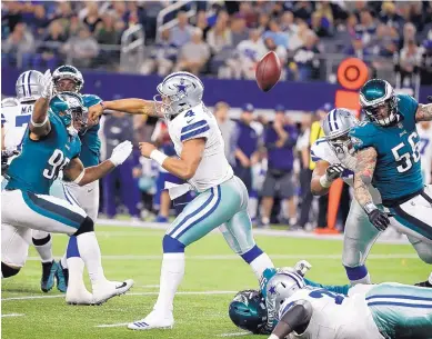  ?? MICHAEL AINSWORTH/ASSOCIATED PRESS ?? Cowboys quarterbac­k Dak Prescott (4) fumbles as he attempts a pass in the second half of Sunday night’s game against Philadelph­ia. Dallas lost 37-9, its worst home loss at 8-year-old AT&T Stadium.