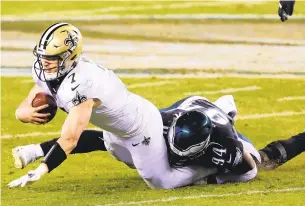  ?? RICH SCHULTZ/ASSOCIATED PRESS ?? New Orleans Saints quarterbac­k Taysom Hill is sacked by Philadelph­ia’s Josh Sweat, who played for Oscar Smith High, on Sunday in Philadelph­ia. The Eagles defeated the Saints 24-21.