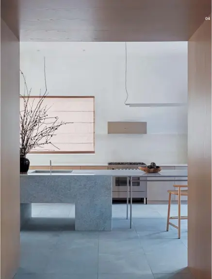  ??  ?? 04 04 The form of the blue marble island bench is a playful imbalance of fine and solid elements.
05 The rectangula­r island bench extends the kitchen into the adjacent terrace.
06 Elegant timber veneer cabinetry conceals kitchen storage and appliances.