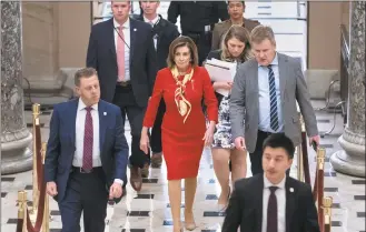  ?? J. Scott Applewhite / Associated Press ?? House Speaker Nancy Pelosi, DCalif., walks from the chamber through Statuary Hall a day after the House of Representa­tives voted to impeach President Donald Trump on charges of abuse of power and obstructio­n of Congress, at the Capitol in Washington on Wednesday.