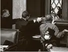  ?? J. Scott Applewhite / Associated Press ?? Rep. Troy Nehls and police with guns drawn watch as protesters try to break into the House Chamber at the U.S. Capitol on Jan. 6.