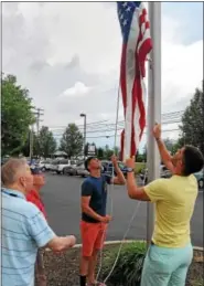  ??  ?? U.S. Marine Corps brothers Cpl. Adam and Lance Cpl. Greg Seanor and veterans Bill Oxenford who was in the U.S. Navy in the Korean War and John Althenn a World War II veteran in the Army Air Corps raise the new U. S. flag on the flag pole in a ceremony...