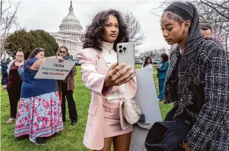  ?? J. Scott Applewhite/Associated Press ?? Devotees of TikTok monitor the House as it slides down a slippery slope Wednesday. More than 170 million Americans use TikTok — many of them as a way to make a living.