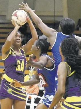  ?? (Photo: Colling Reid) ?? Player-of-match goal attack Odeacha Johnson (left) of Saint Ann Orchid prepares to shoot ahead of defenders A Linton (second right) and Shannika Johnson (second left) of Saint Catherine Racers during the 2023 Seprod/nj Elite League at the NISC on Friday. At right is Johnson’s scoring partner goal shooter Sabrina Spence.