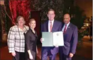  ?? FRAN MAYE — DIGITAL FIRST MEDIA ?? Denis O’Brien, second from right, accepts a citation from Chester County commission­ers Kathi Cozzone, Michelle Kichline and Terence Farrell after being named 2018 Executive of the Year by the Chester County Chamber of Business and Industry.