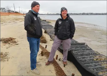  ?? ?? Tim Dillingham (left) and Modjeski examine logs of coconut husk Jan. 31 along the bank of the Shark River.