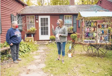  ?? MARKMIRKO/HARTFORD COURANT ?? Ashford retiree Jane Allely, 74, left, talks with Melissa McDonough outside Allely’s home. Allely, who goes by“Cricket,”has made and donated more than 7,000 face masks with her cousin Nancy Whitham, who lost her job due to the pandemic.