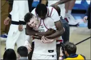  ?? ROSS D. FRANKLIN — THE ASSOCIATED PRESS ?? Uconn center Youssouf Singare, rear, hugs orward Alex Karaban after the game against Alabama at the Final Four, Saturday, in Glendale, Ariz.