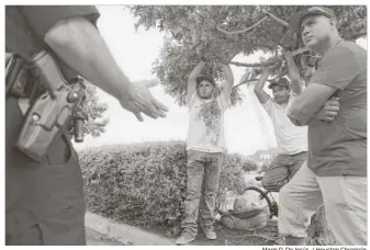  ?? Marie D. De Jesús / Houston Chronicle ?? Fabian Mendoza, right, and his fellow day laborers aren’t convinced by Yañez’s pleas for them to trust HPD officers. And what about the racists? Mendoza asks of police treatment of Latinos.