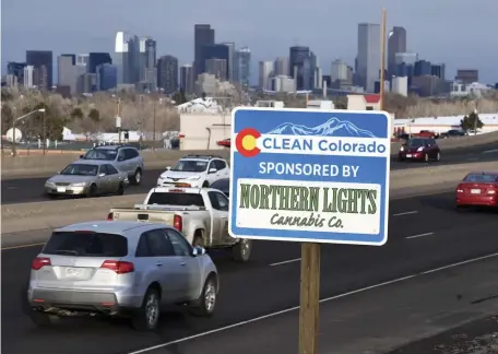  ?? ANDY CROSS / THE DENVER POST ?? KEEPING THE ROADS CLEAN: A Clean Colorado highway sign sponsored by the Northern Lights Cannabis Co. is displayed on 6th Avenue in Denver. Marijuana companies, which face stiff restrictio­ns from normal advertisin­g that would likely be seen by children, have taken to road-cleanup sponsorshi­ps.