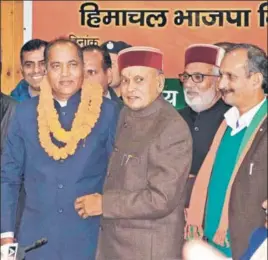  ?? PTI ?? Former CM Prem Kumar Dhumal congratula­ting CMelect Jai Ram Thakur in Shimla on Sunday.
