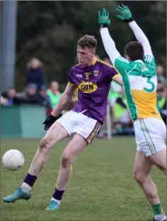  ??  ?? Nick Doyle shoots as Offaly defender Paul McConway tries to block.