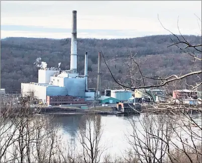  ?? Contribute­d photo ?? The NRG plant at 1866 River Road in Middletown is shown from the east shore of the Connecticu­t River. The company plans to replace two natural gas-fired turbines on the site. Local environmen­talists and climate activists are concerned it will emit a much higher level of CO2 than the present one, which is only online a few days a year.