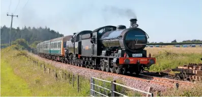  ?? G.d. kinG ?? NEr ‘t2’ 0-8-0 No. 2238 and Br ‘4mt’ 2-6-4t No. 80078 drift down danemoor bank towards kimberley park with the 4pm derehamwym­ondham Abbey train on June 28, the first day of the mid-Norfolk railway’s summer gala.