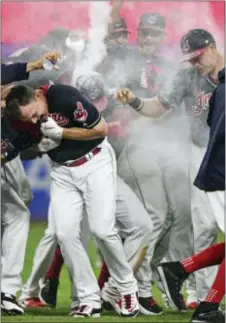  ?? THE ASSOCIATED PRESS — DAVID DERMER ?? Jay Bruce, left, and his Cleveland teammates have had plenty to celebrate as the Indians’ winning streak has stretched to an American League record 22 games. But without a World Series title since 1948, the winning streak only increases the pressure...