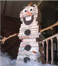  ??  ?? ■ The Hughes Springs library personnel are also artists as this snowman made of books demonstrat­es. He is residing in the window of the library.