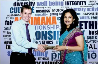  ??  ?? HEAD OF GROUP SUSTAINABI­LITY AND CORPORATE COMMUNICAT­ION SHIROMI MASAKORALE HANDING OVER THE SCROLL CONTAINING THE FORMAL DECLARATIO­N TO HEMAS CEO STEVEN ENDERBY