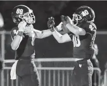  ?? ?? Smithson Valley's Dylan Domel (80) celebrates his 54-yard touchdown reception with Cole Douglass in the fourth quarter.