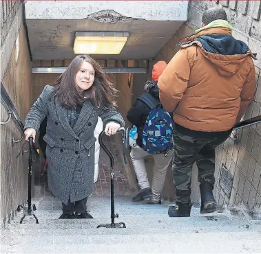  ?? RENE JOHNSTON TORONTO STAR ?? Jessica Geboers makes her way up the stairs at College Station. She rates the TTC’s accessibil­ity as a six out of 10.