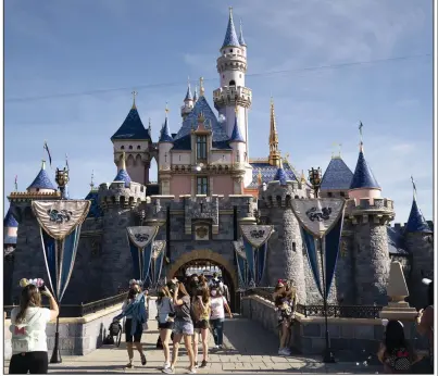  ?? ?? Visitors pass through Disneyland in Anaheim, Calif., in this file photo. (AP)