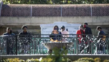  ?? AP PHOTO/BRANDEN CAMP ?? People visit the eternal flame at the tomb of Rev. Martin Luther King Jr. and his wife Coretta Scott King on Monday, to celebrate the Martin Luther King Jr. holiday, in Atlanta.