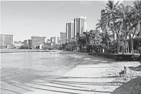  ?? CALEB JONES/AP ?? Waikiki Beach in Honolulu is nearly empty Oct. 2. After a summer marked by a surge of coronaviru­s cases in Hawaii, officials plan to reboot the tourism-based economy.