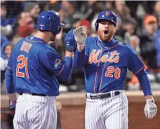  ?? ROBERT DEUTSCH, USA TODAY SPORTS ?? The Mets’ Lucas Duda, left, greets Daniel Murphy after Murphy’s two-run homer in the first inning of Game 2 on Sunday.