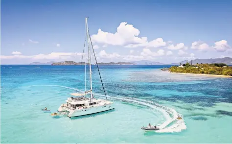  ?? STEVE MCCAULEY ?? After a pandemic lull, more people of comfortabl­e, but not necessaril­y extraordin­ary, means are chartering crewed boats in the Caribbean. Above, the yacht Bluewinds, anchored off St. Thomas.