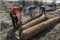  ?? BEN HASTY — MEDIANEWS GROUP ?? Berks County Conservati­on District employees, from left, Kent Himelright, Evan Corondi and Juan Bol prepare to install a coir log along Valley Run Creek in Washington Township.