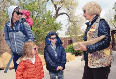  ?? JIM THOMPSON/JOURNAL ?? ABQ BioPark Zoo docent Peggy Hughes holds a rhinoceros horn Friday while explaining the myths associated with the use of ground rhino horn in Asian folk remedies and the tragic consequenc­es to the world rhino population­s. At left is Aminda Bower and...