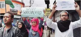  ?? PTI ?? People display placards while taking part in silent peace rally in Darjeeling on Sunday