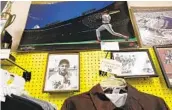  ?? JOHN GASTALDO ?? A framed photo of San Diego legend Ted Williams hangs on a pegboard at A&B Sporting Goods.