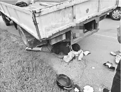  ??  ?? The injured motorcycli­st lies beneath the lorry following the crash.