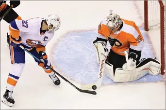  ?? FRANK GUNN - THE CANADIAN PRESS ?? Flyers goaltender Carter Hart, right, makes a save against New York Islanders left wing Anders Lee Saturday night. As good as Hart was this season, it’s too early to pin the savior label on him.