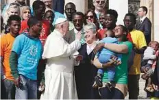  ?? AP ?? Pope Francis meets a group of refugees during his weekly general audience at the Vatican yesterday.