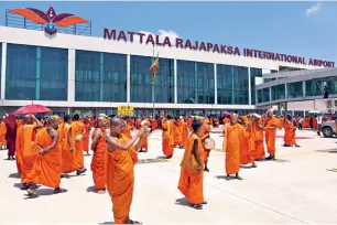  ?? SANKA GAYASHAN/AP ?? WHITE ELEPHANT? Monks at the Mattala internatio­nal airport