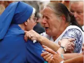  ?? AP photo ?? French nun greets a resident during a gathering in a town park for a solemn homage to the Rev. Jacques Hamel in Saint-Etienne-du-Rouvray, Normandy, France