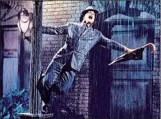  ??  ?? The inimitable Gene Kelly splashes around the MGM back lot in the iconic title number from Singin’ in the Rain.
