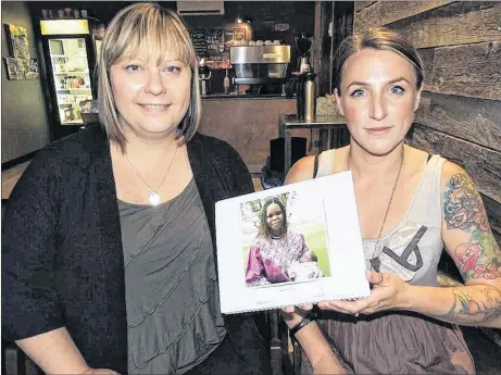  ?? ROSALIE MACEACHER/SPECIAL TO THE NEWS ?? Lindsay Corbin, left, and Shannon MacDonald look over a calendar of nursing mothers they are using as a model for their project with the Pictou County Baby Friendly Network.