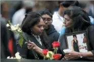  ?? MARK LENIHAN - THE ASSOCIATED PRESS ?? A woman leaves flowers at the North Pool during a ceremony marking the 17th anniversar­y of the terrorist attacks on the United States on Tuesday, Sept. 11, 2018, in New York.