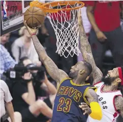  ?? NATHAN DENETTE / THE CANADIAN PRESS FILES ?? Cleveland Cavaliers forward LeBron James, left, drives past Toronto Raptors forward James Johnson during their Eastern Conference Final matchup last May.