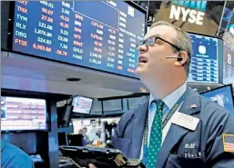  ??  ?? Numbers don’t lie: A trader watches the market’s fluctuatio­n Wednesday.