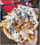  ?? COURTESY OF BABA’S HOT CHICKEN ?? Baba’s loaded fries are topped with chopped chicken, simple slaw, cheese, ranch and house sauce.
